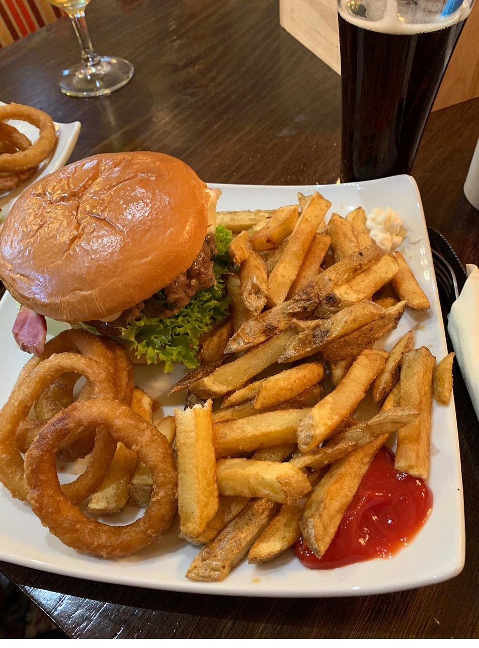 Classic beef burger with onion rings and fries
