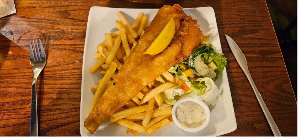 Beer battered fish and chips with fries and salad